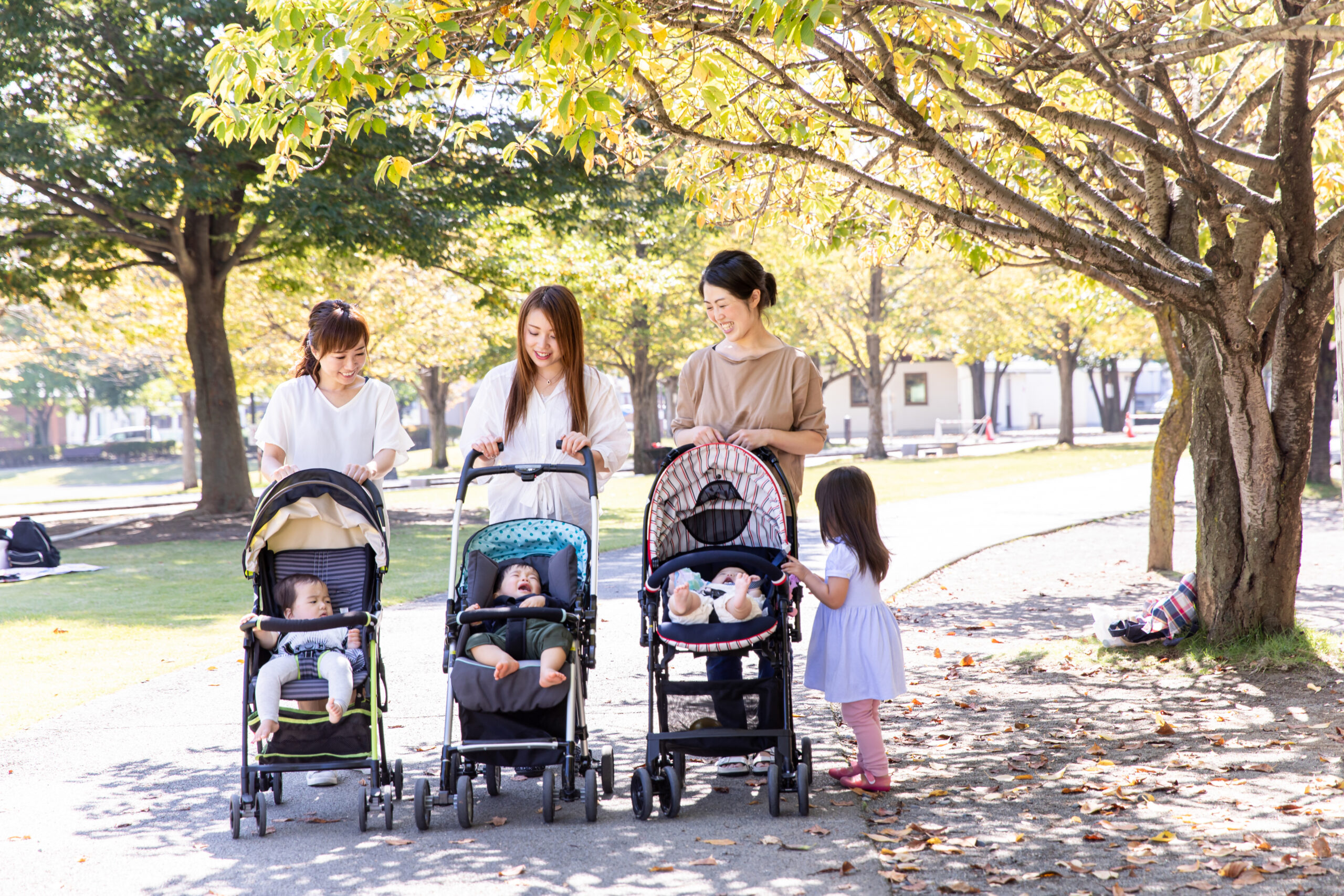Parents with babies in strollers at a Tokyo park